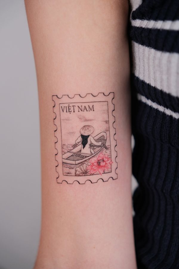 Vietnam stamp-style tattoo of woman rowing boat with lotus flower – tattoo Hanoi