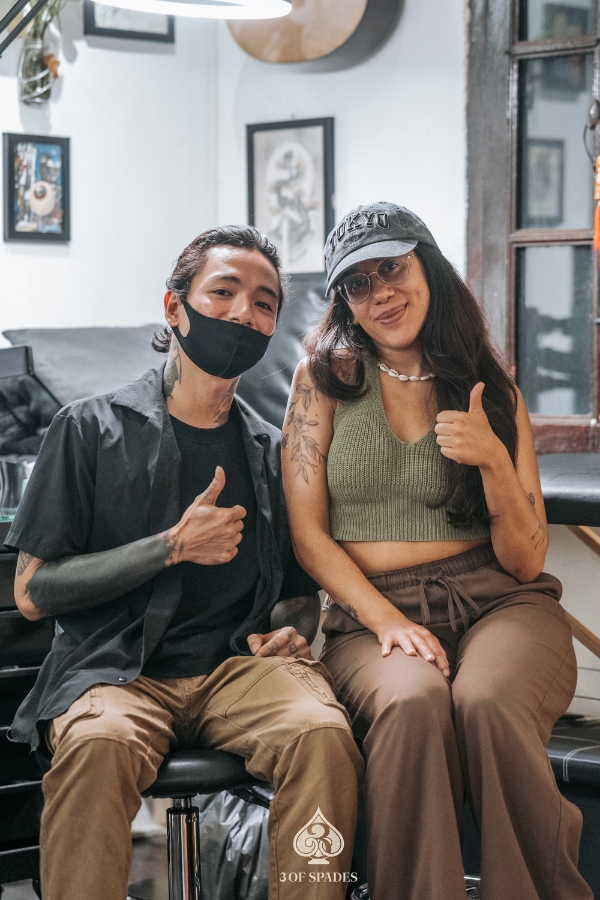 Tattoo client and artist giving thumbs up after a completed tattoo session at 3 Of Spades Tattoo Studio in Hanoi.