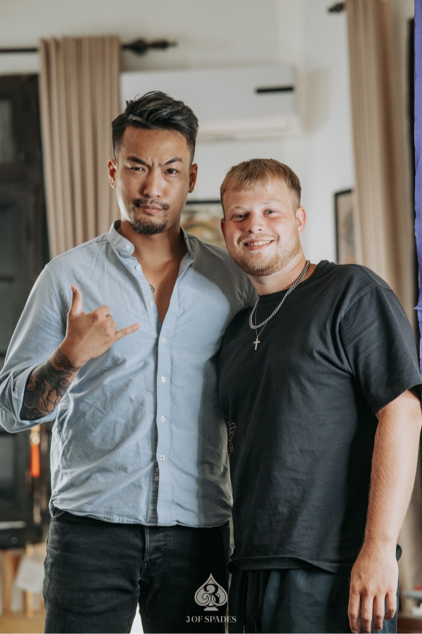 Tattoo artist and guest smiling after tattoo session at 3 Of Spades studio in Hanoi