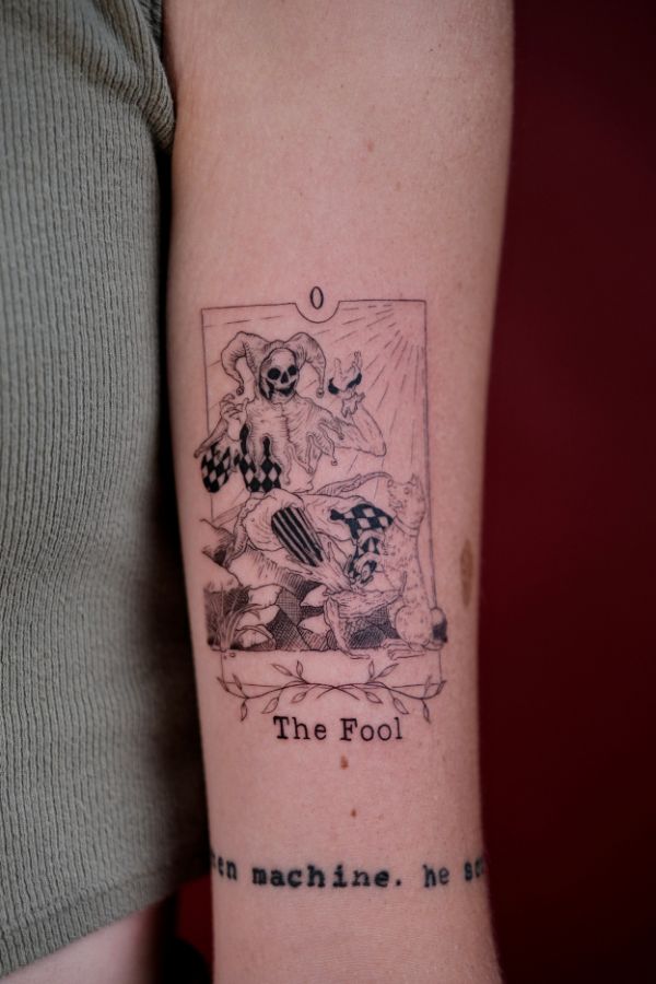 Blackwork tarot card tattoo of The Fool with jester skeleton – tattoo Hanoi