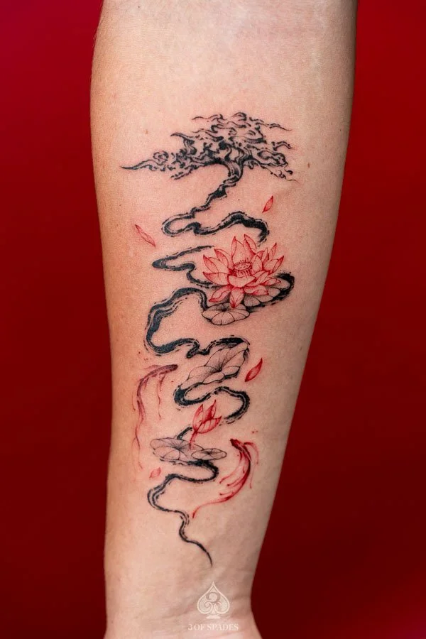 Abstract Tree and Red Lotus, Koi Fish Tattoo featuring flowing black tree branches, vivid red lotus flowers, and elegant koi fish imagery at 3 of Spades Hanoi Tattoo.
