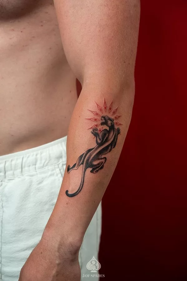 Detailed Black and Grey realism black panther tattoo with bared fangs on forearm by 3 Of Spades Hanoi.