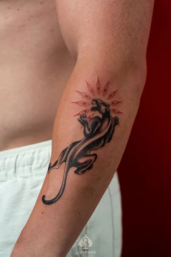 Detailed Black and Grey realism black panther tattoo with bared fangs on forearm by 3 Of Spades Hanoi.