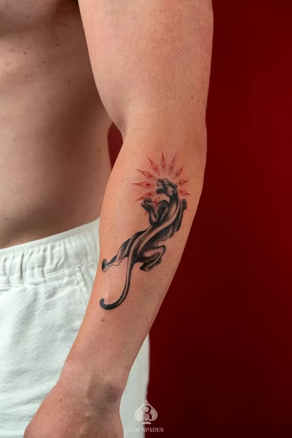 Detailed Black and Grey realism black panther tattoo with bared fangs on forearm by 3 Of Spades Hanoi.