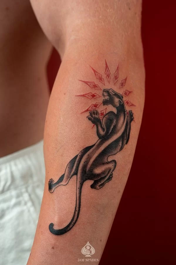 Detailed Black and Grey realism black panther tattoo with bared fangs on forearm by 3 Of Spades Hanoi.