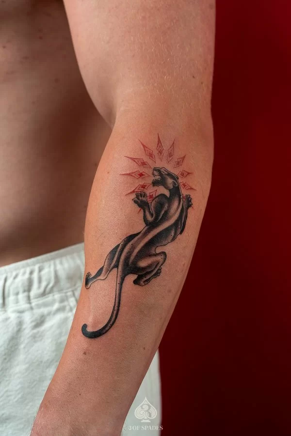 Detailed Black and Grey realism black panther tattoo with bared fangs on forearm by 3 Of Spades Hanoi.