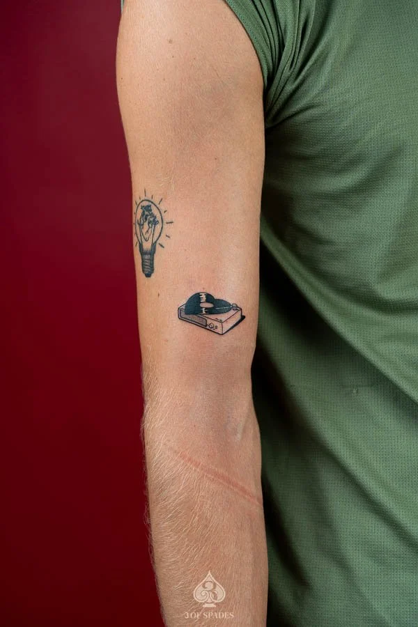 Vinyl Record Player and MP3 Blackwork Tattoo featuring retro music technology, bold black ink, and graphic details at 3 of Spades Hanoi Tattoo.