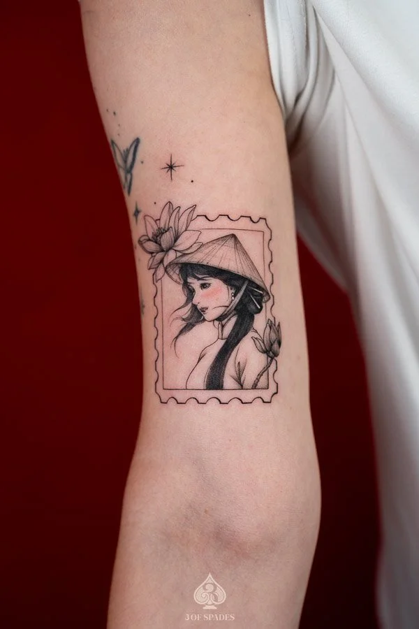 Vietnamese Woman Lotus Stamp Tattoo concept featuring a traditional Vietnamese woman portrait, delicate lotus flowers, and a vintage postage stamp border inspired by Vietnamese cultural imagery.