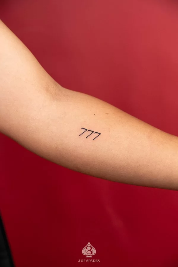 777 angel number tattoo.