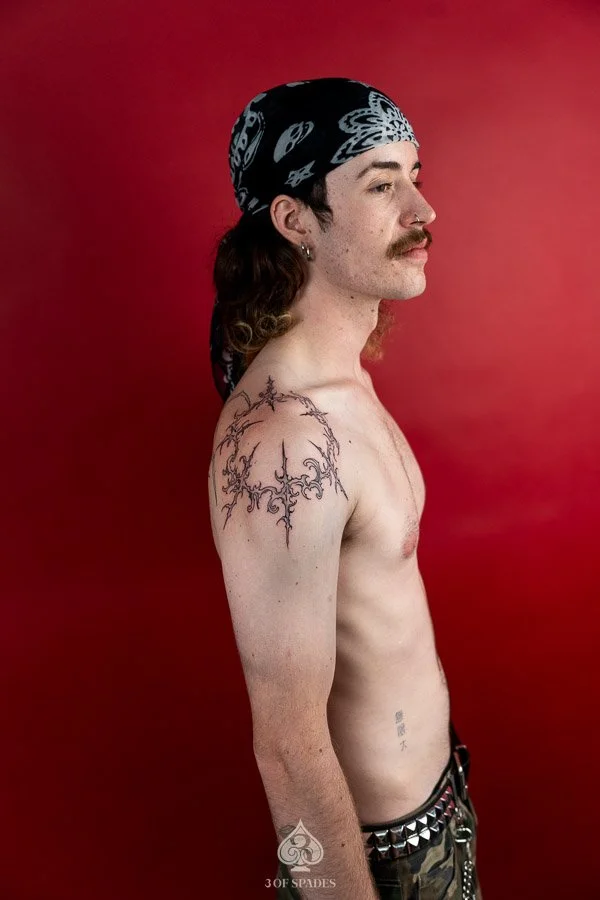 Gothic Tattoo on Shoulder by Hukk featuring sharp symmetrical ornamental linework and abstract black ink details at 3 of Spades Hanoi Tattoo.