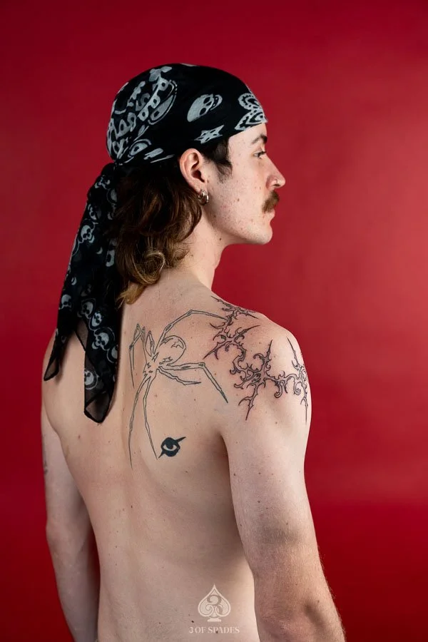 Gothic Tattoo on Shoulder by Hukk featuring sharp symmetrical ornamental linework and abstract black ink details at 3 of Spades Hanoi Tattoo.