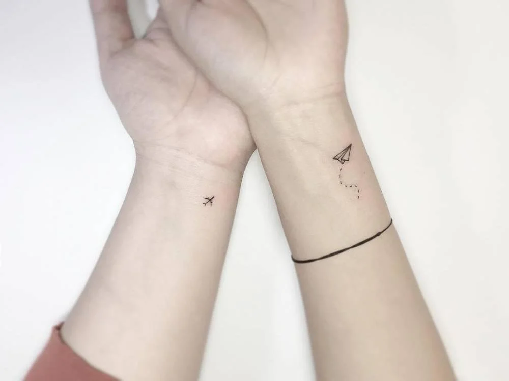 matching airplane couple tattoo
