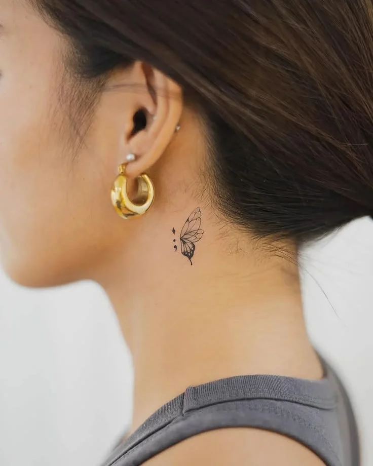 tiny butterfly behind ear tattoo