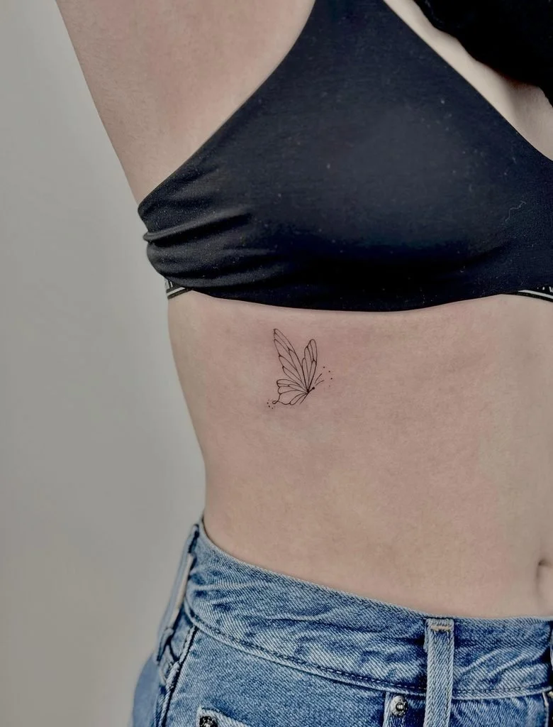 delicate butterfly side breast tattoo