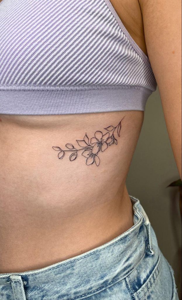 small cherry blossom breast tattoo