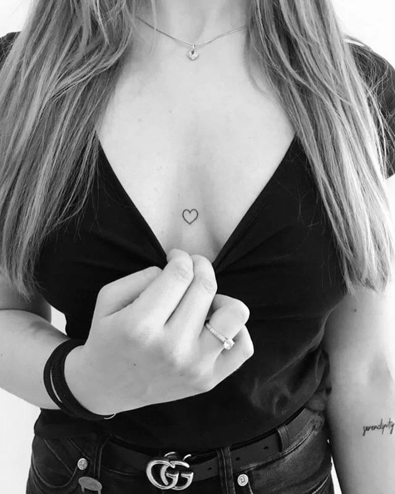minimal heart breast tattoo