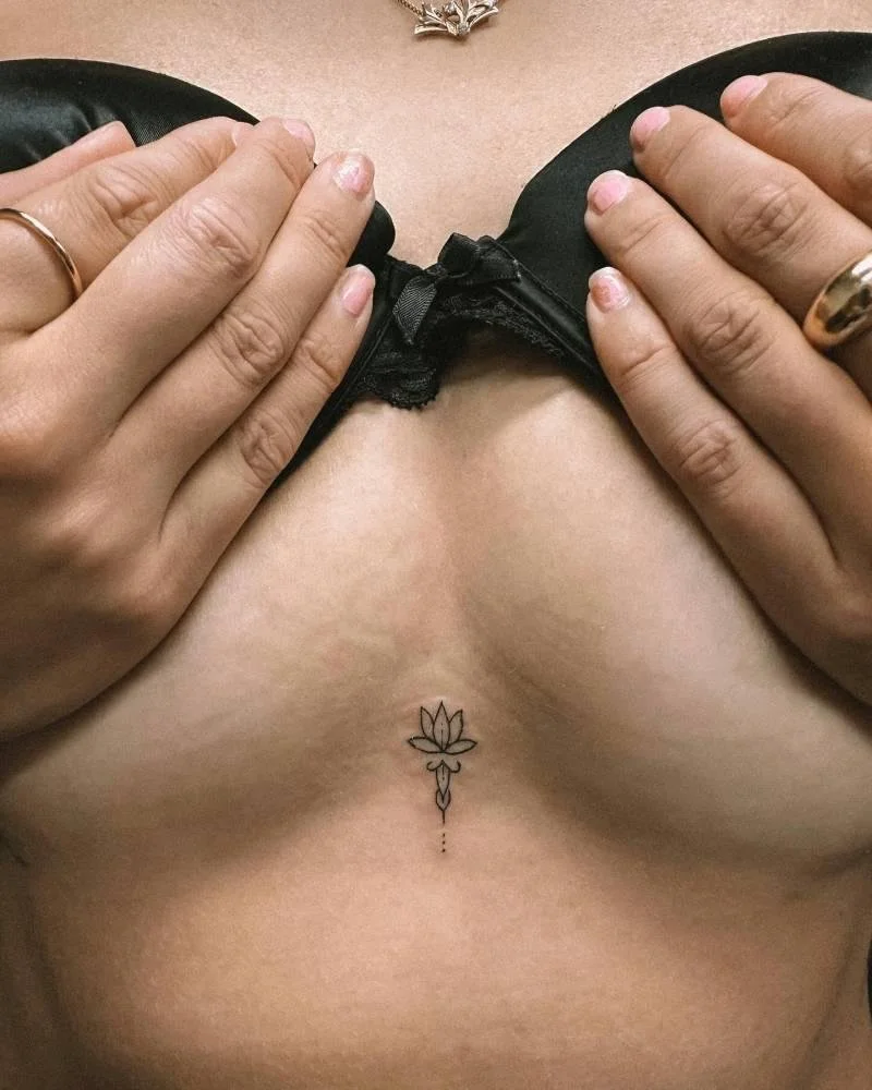 minimal lotus breast tattoo
