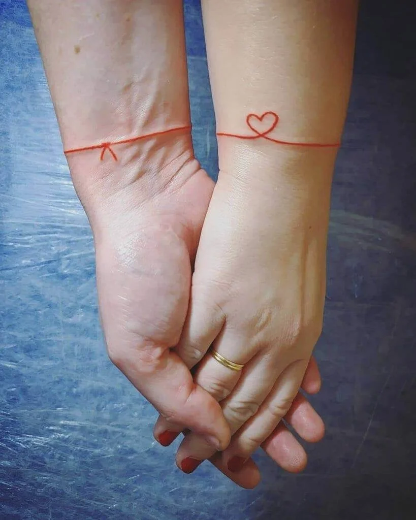 red strings design for couple tattoo