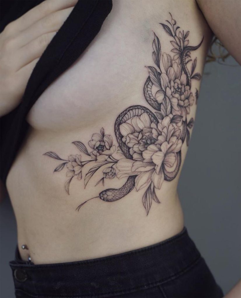 snake side breast tattoo