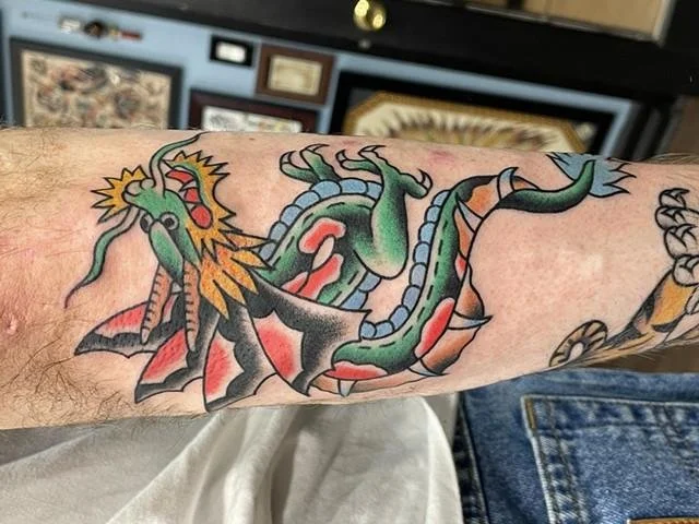 An Oldschool Dragon Tattoo is a dragon design illustrated using the visual conventions of American traditional